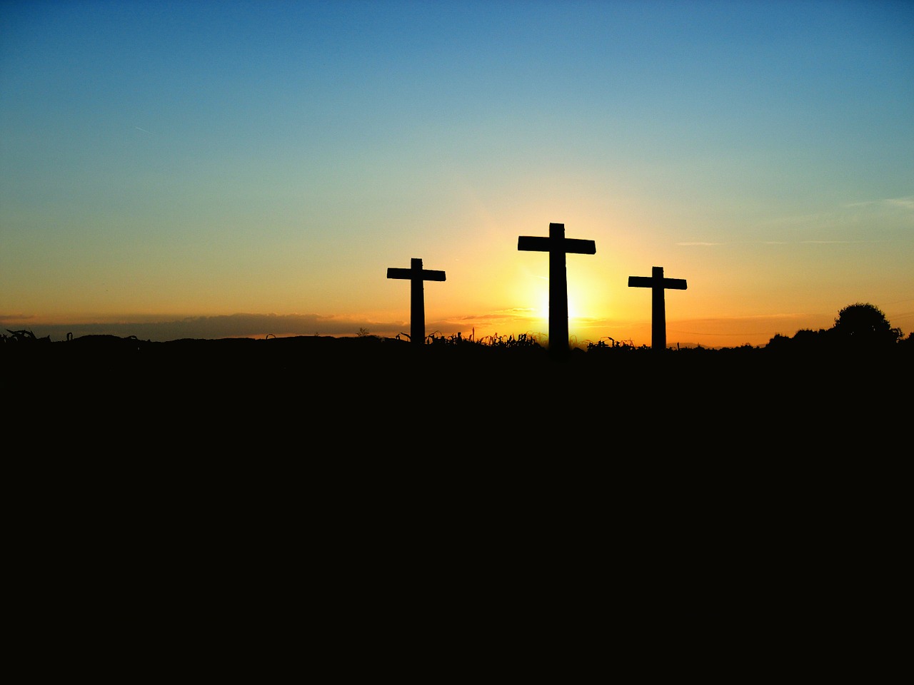 Three crosses in a sunset